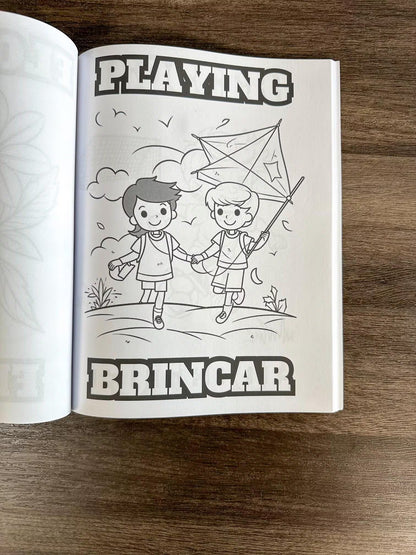 Open book with black and white illustration of two children playing with a kite, on a wooden surface. How To Cook Portuguese Stuff coloring book

